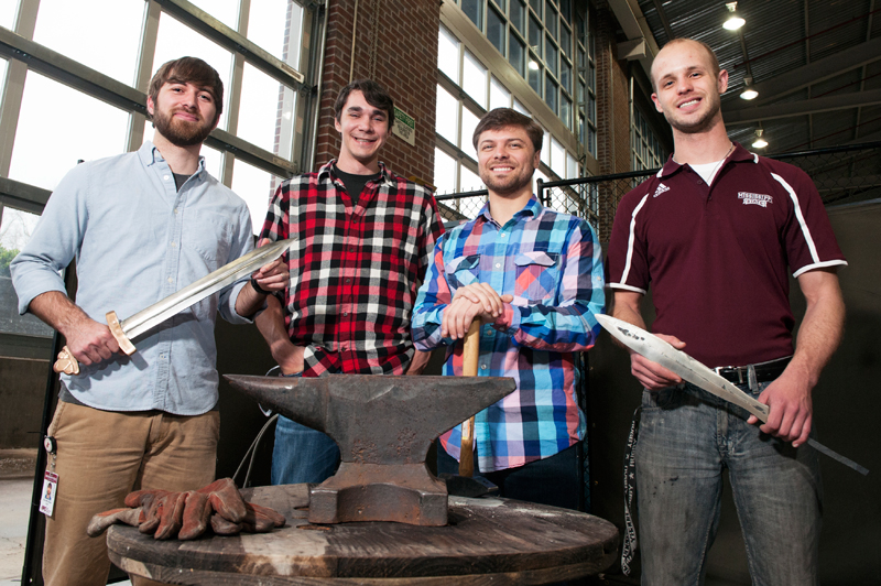 From L-R: Team members Zack McClelland, Jake House, Blake Brown and William Williams stand with their swords and blacksmith equipment.