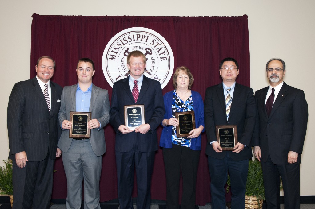 The research accomplishments of four members of the James Worth Bagley College of Engineering earned time in the spotlight at an annual event. From L-R: MSU President Mark Keenum, Dexter Duckworth, Trenton Ricks, Teresa Stewart, Yong Fu, and Massoud Rais-Rohani, associate dean for research and graduate studies. (photo by Beth Wynn / © Mississippi State University)