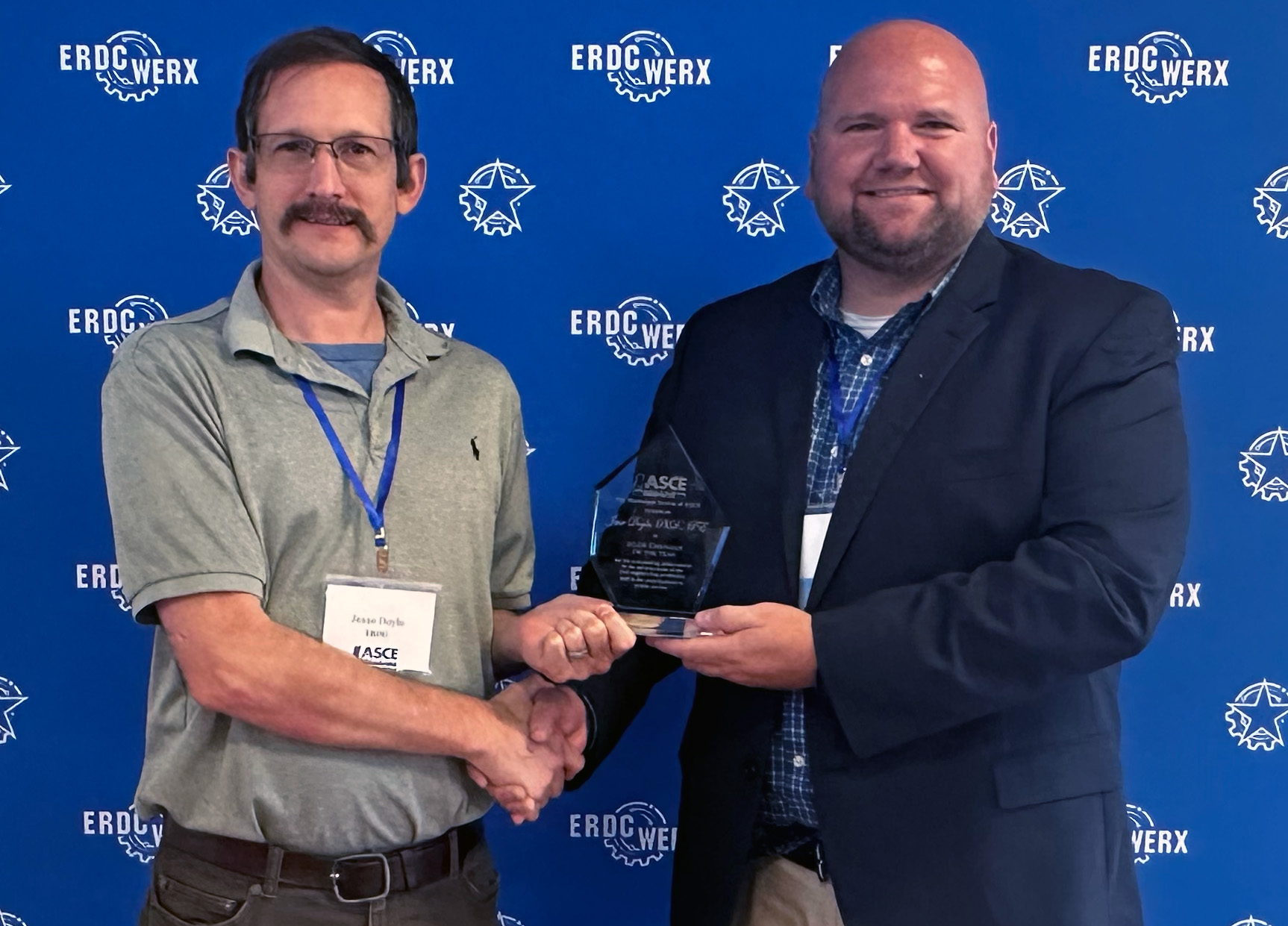 Jesse Doyle, left, receives the Engineer of the Year award from past section president Will Carruth.