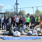 Group shot of Catalpa Creek clean up participants posing with the trash they picked up.