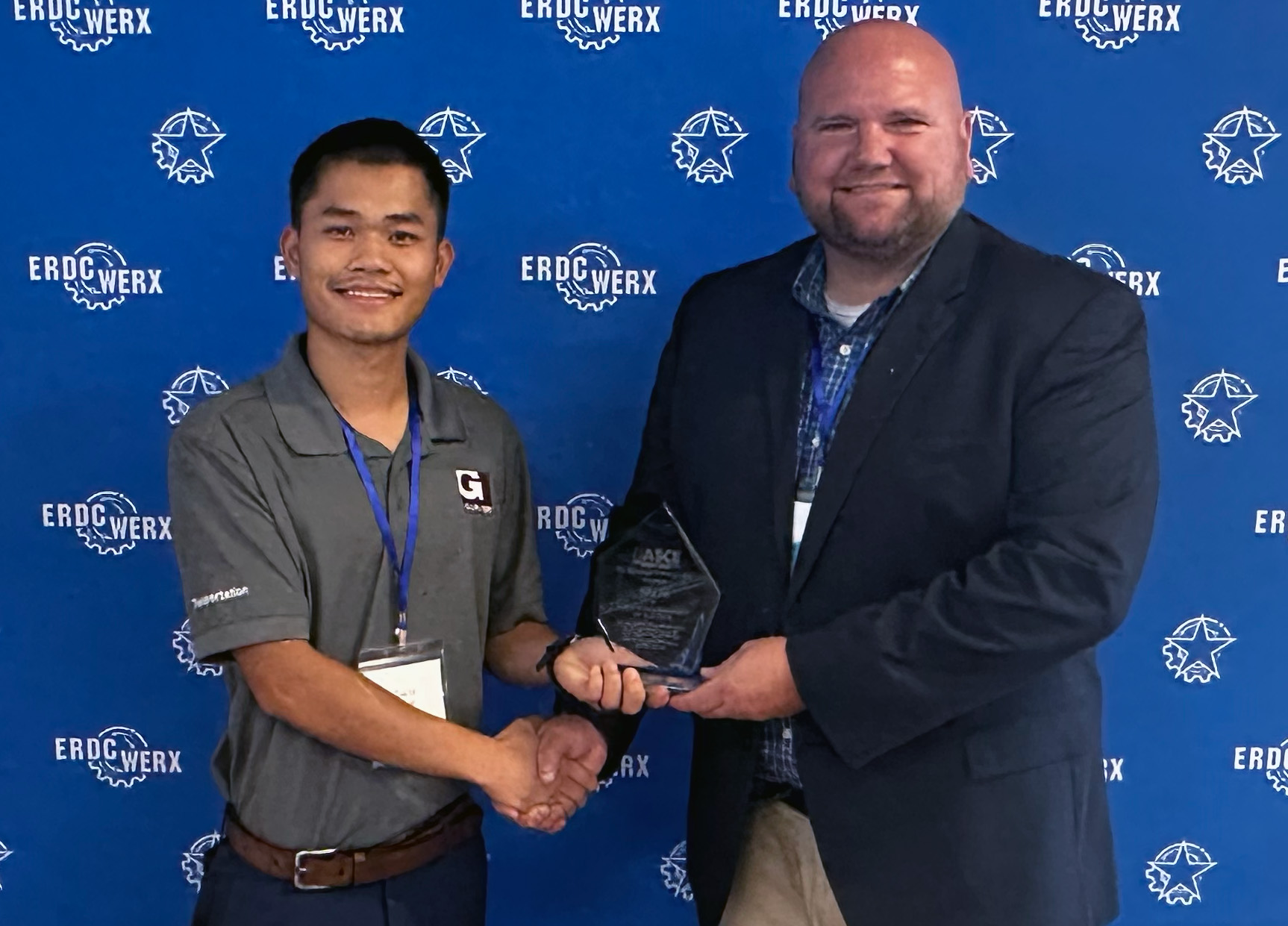 Ziai Li, left, receives the Young Engineer of the Year award from past section president Will Carruth.