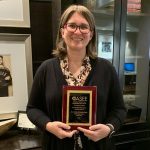 Lesley Strawderman holding her teaching award from ASEE